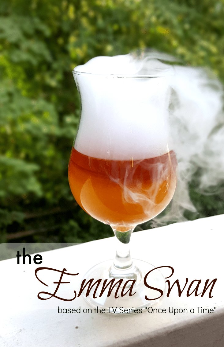 alcoholic drink in clear glass with smoke billowing out of it
