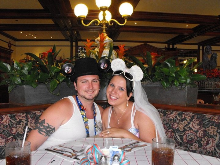 A honeymoon at Walt Disney World is worth every moment. Here is why! #disneymoon #disneyhoneymoon couple together in disney honeymoon ears at restaurant