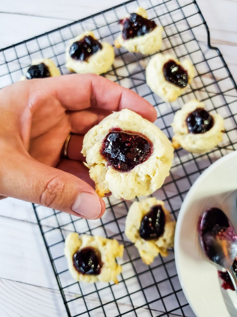 marionberry thumbprint cookie held by hand