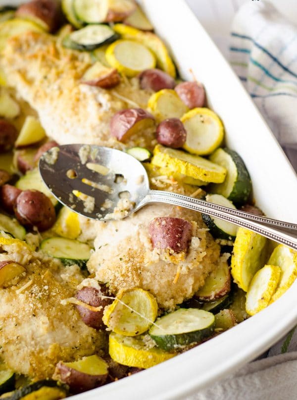 baked chicken with vegetables in white pan