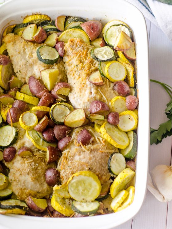 chicken and vegetables in white baking pan