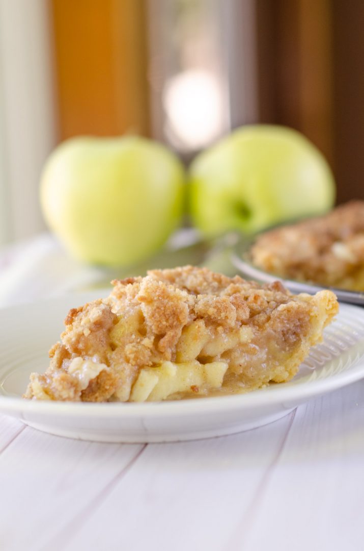 crumble pie on white plate with apples