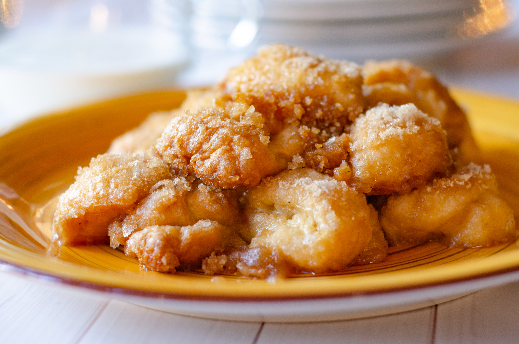 monkey bread coated in sugar on yellow plate